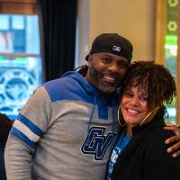 Man and woman standing together smiling at camera